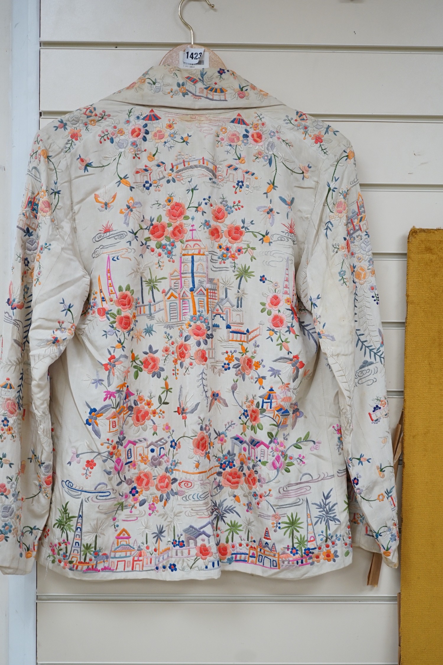 A Chinese 1930’s cream silk and multi coloured embroidered evening jacket